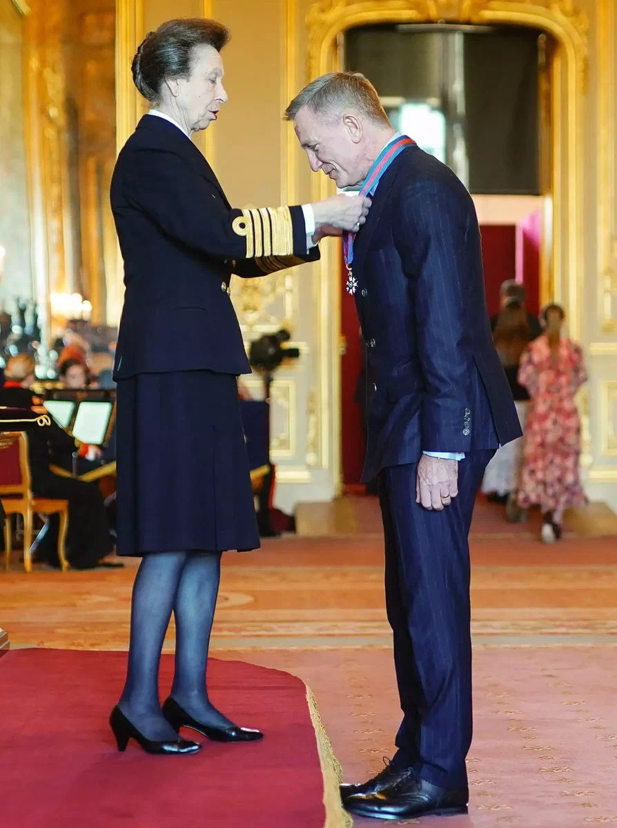 Prince Anne bestows the Order of St Michael and St George on Daniel Craig — the same honor his character James Bond received. | CREDIT: THE ROYAL FAMILY/TWITTER